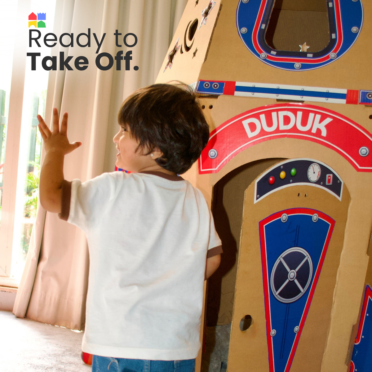 Boy waving beside his DUDUK Rocket, ready for take-off