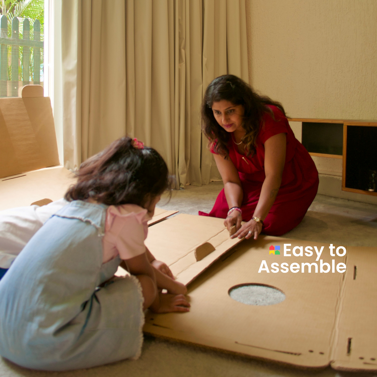 Girl and her mother putting together the panels of a DUDUK Rocket, no tools needed