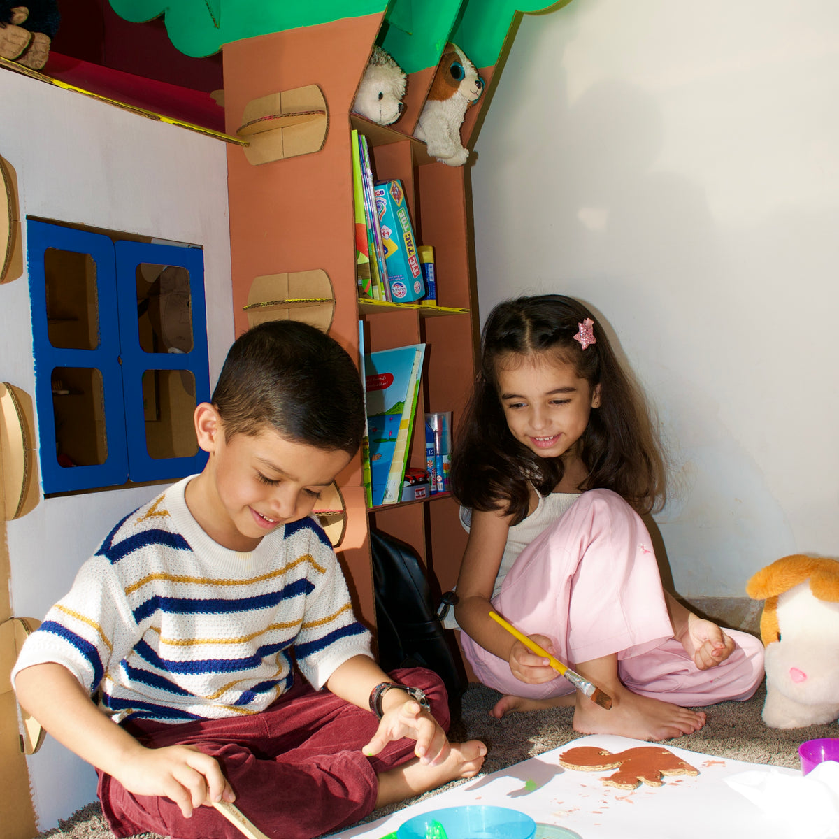 Boy painting jungle animals on a DUDUK Tree House