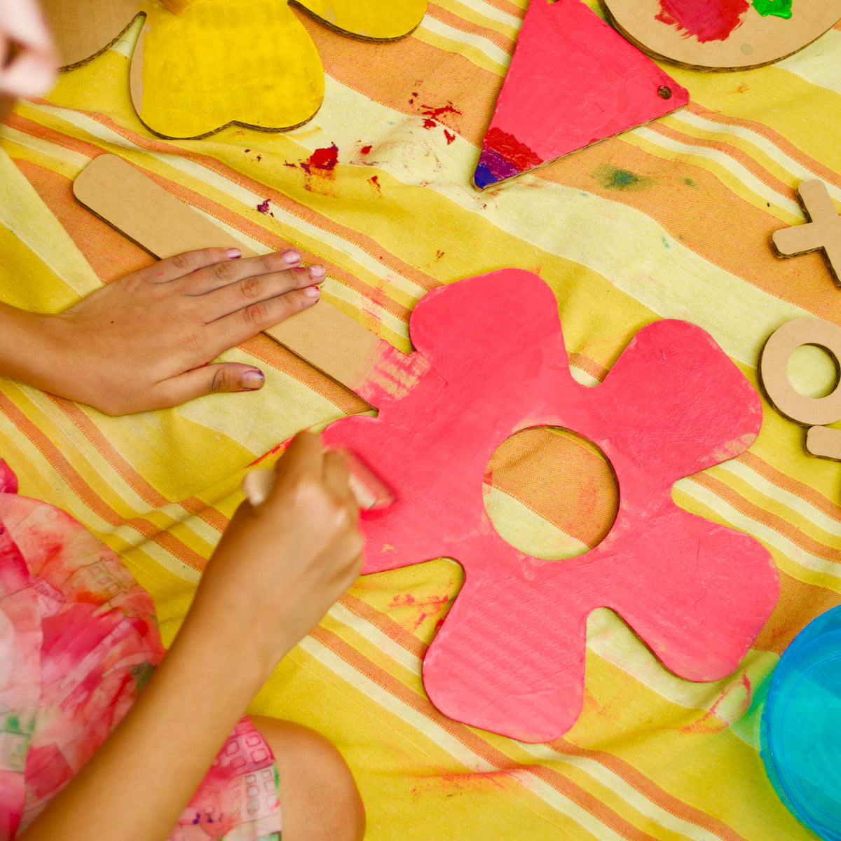 Child painting a DUDUK Flower Kit flower